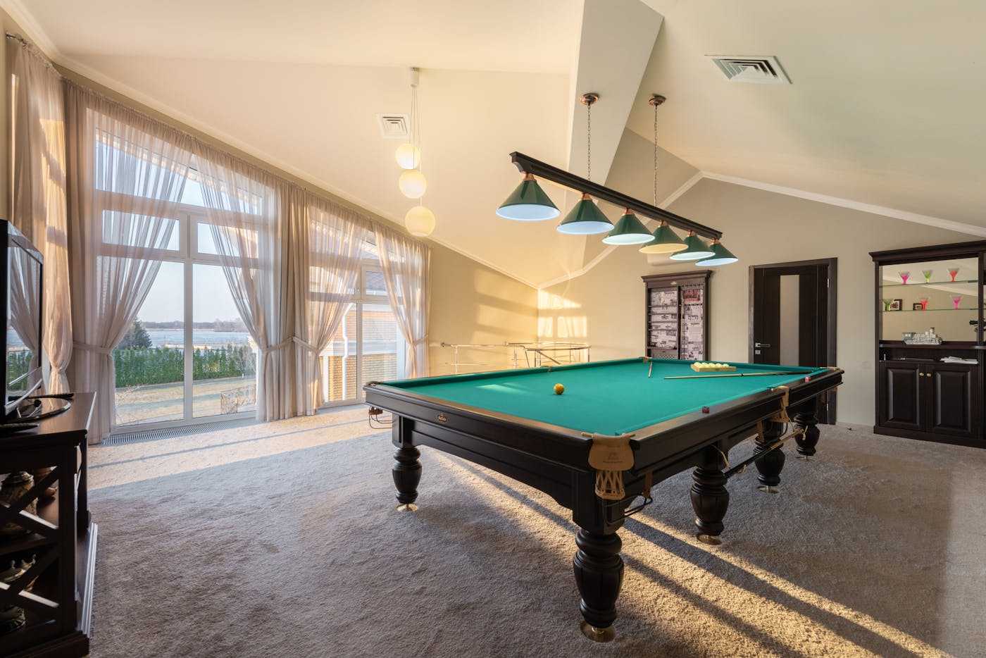 A slate billiards table set up in a recreation room — part of the pool tables and billiards lineup at Highland Pool & Spa.